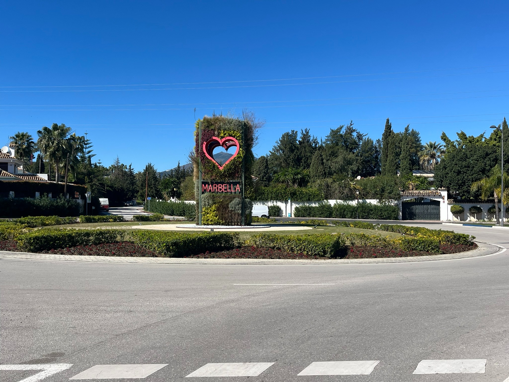 Marbella entrance sign with La Concha in the distance